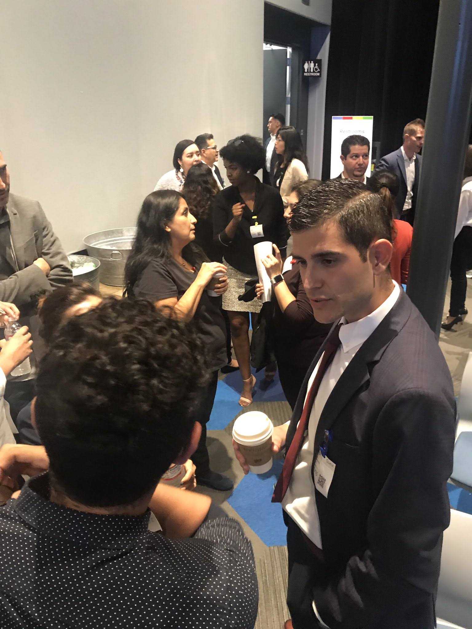 Attendees talking during the symposium