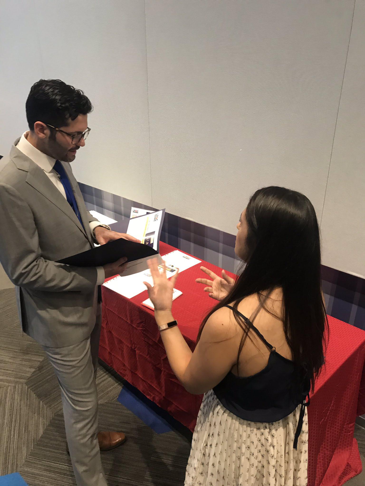 Attendees meeting at the symposium registration area