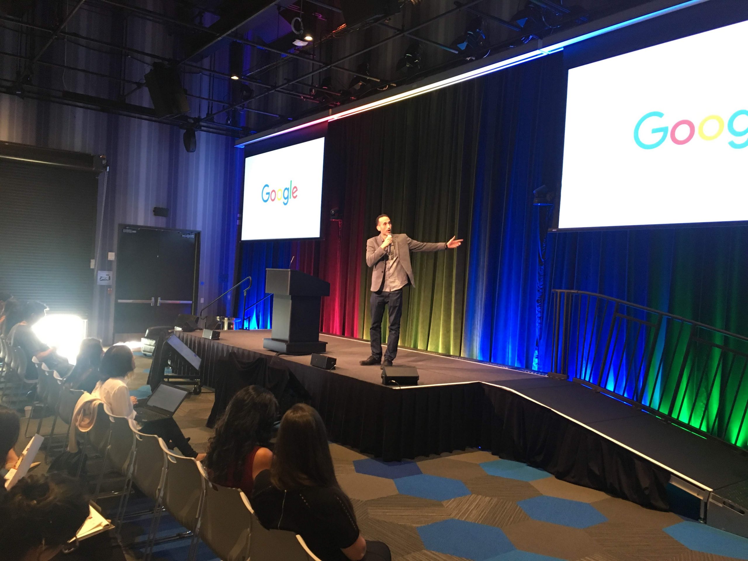 Wide view of the symposium stage and audience
