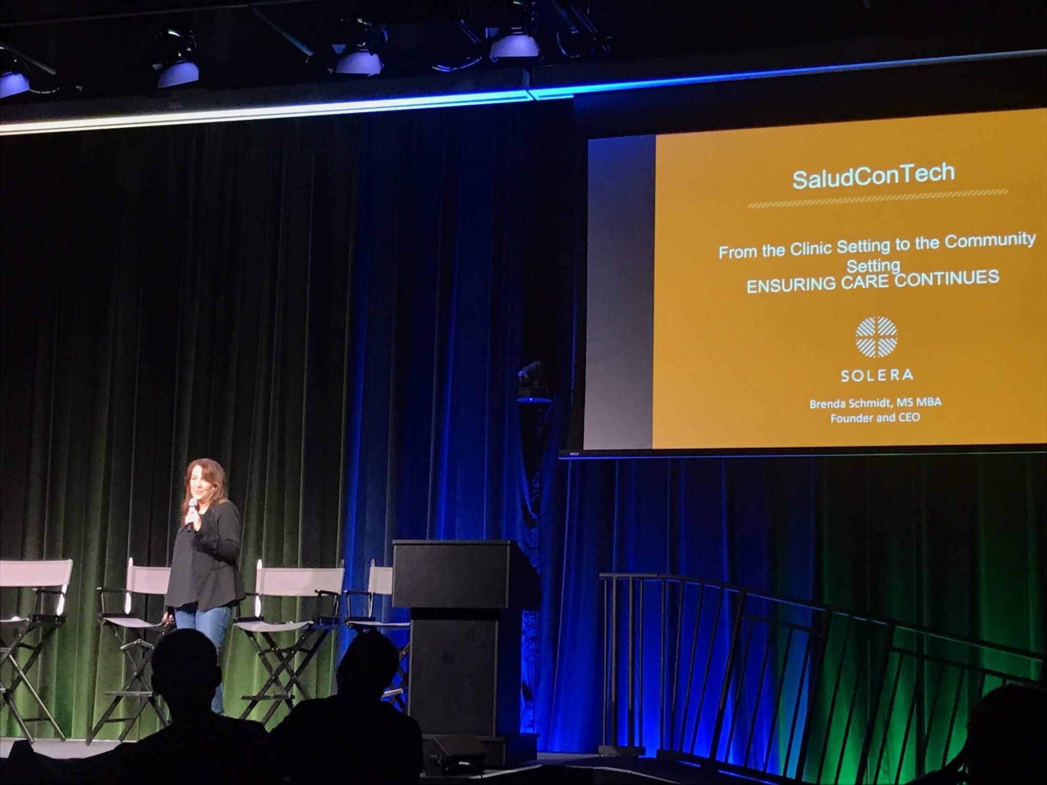 Speaker presenting onstage at the SaludConTech symposium